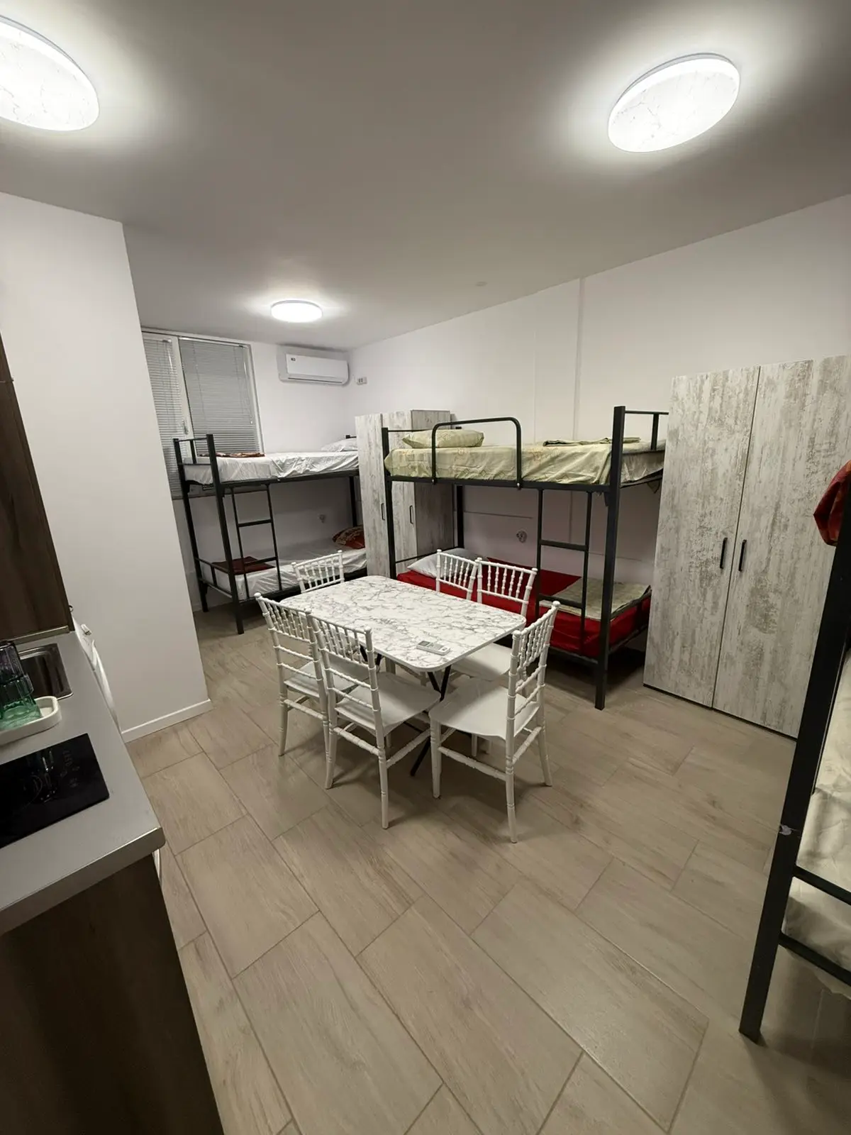 Furnished worker room with beds and a table